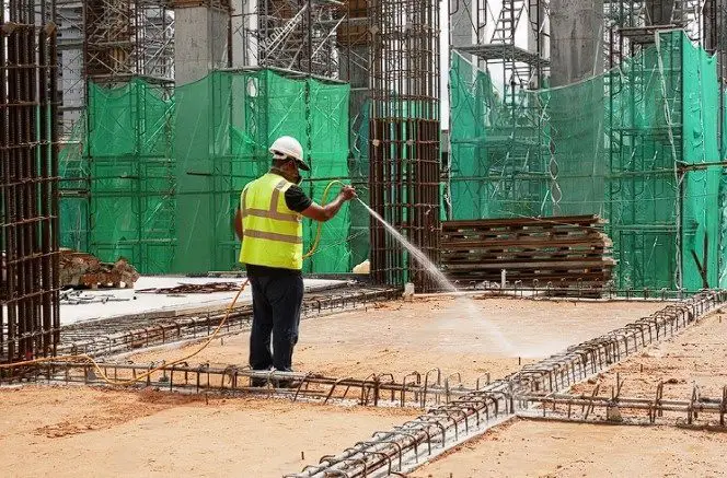 antitermite application of the ground prior to casting of the slab by the construction worker
