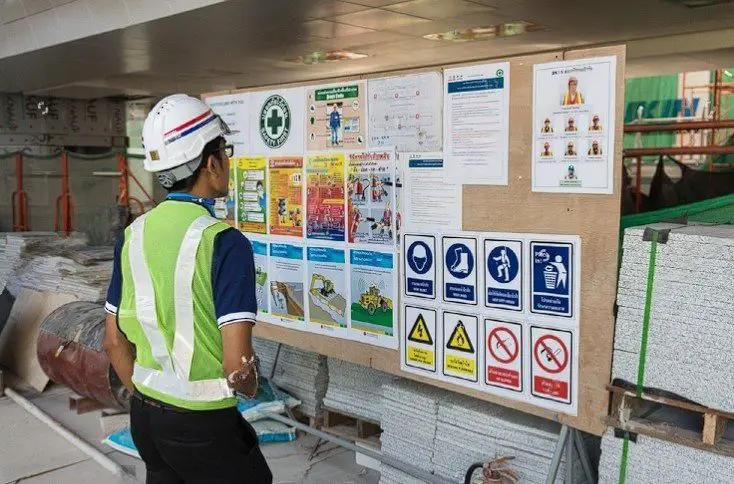 an engineer reading posted work instruction at the site