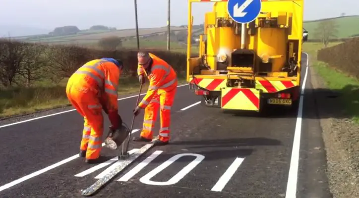equipment applying thermoplastic paint on the road